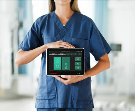 Nurse holding the Vitacon Vitascan eVue Portable Bladder Scanner in a hospital setting
